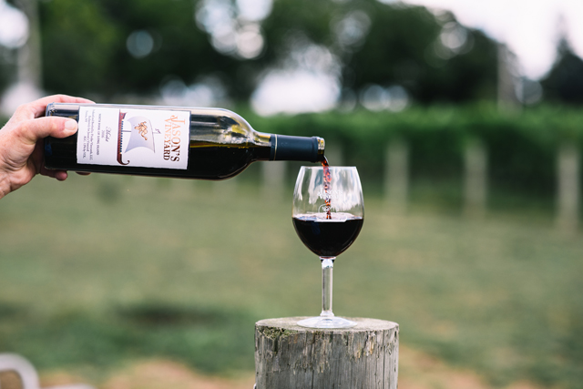 Betsy Waugh pours a glass of wine at Jason's Vineyard in Jamesport. (Credit: David Benthal)