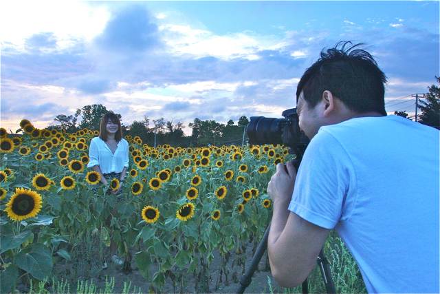 Tom Lin of Flushing, Queens composes a portrait of his girlfriend, Fang Chen, also Flushing, in the field next to Bayview Farms and Market in Aquebogue.