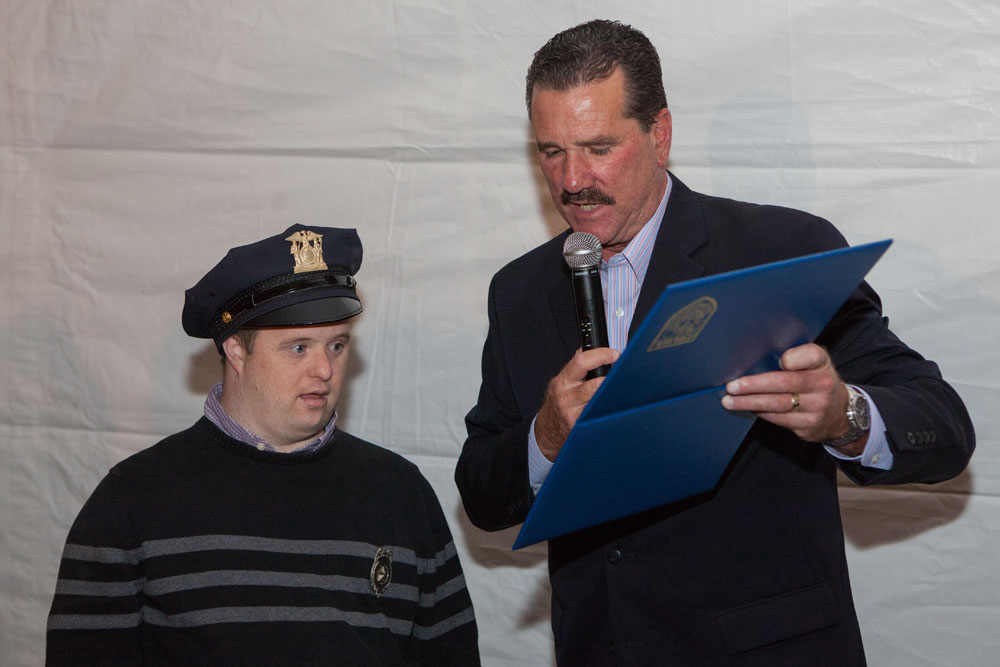  Southold Police Chief Martin Flatley presents Paul Drum with a proclamation naming him "Chief for a Day."