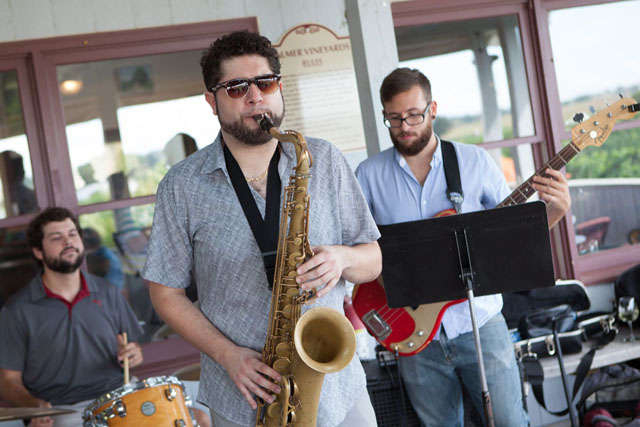 Ladies Drink 4 Free performing. Drummer Robby Deitz, Mikey Vitale on the saxophone, and guitarist Edward Neving. Mike Rad is playing piano off-camera.
