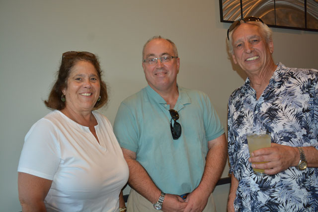 Angela Devito of South Jamesport, Bill Andes of Aquabogue and Jack Wade, also of Aquabogue, all stopped by Mazi to wish John Mantzopoulos well (Credit: Monique Singh-Roy)