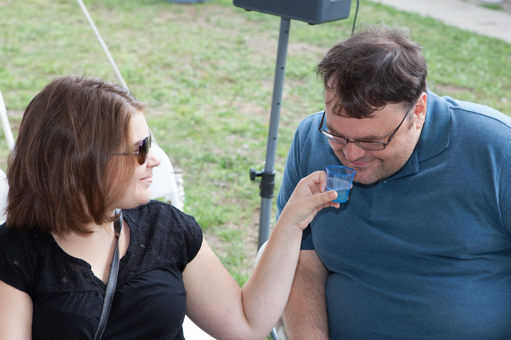 Kerri Dobbs of Shirley offers a sniff of her garlic tea to Anthony Stapon of Riverhead.