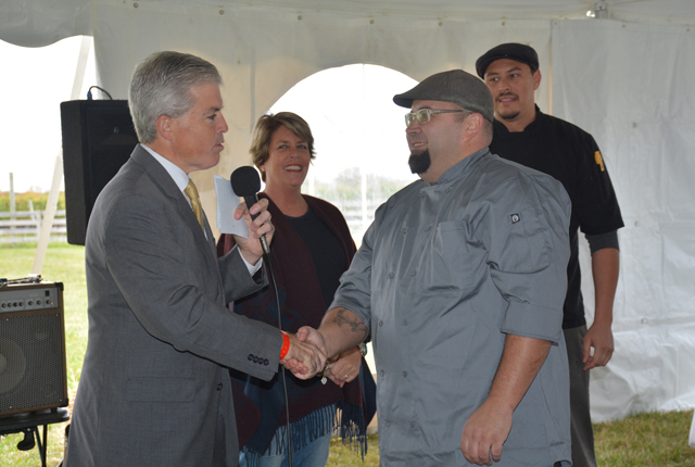 Suffolk County Executive Steve Bellone and East End Mushroom Company co-owner Jane Maguire congratulate cook-off winner Chef De Cuisine Brian Szostak of Noah's (Credit: Monique Singh-Roy)