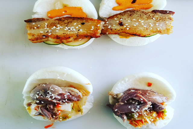 Pork belly buns with pickled cucumber and sriarcha mayo & crescent farm duck confit buns on a steamed bun with fermented kimchi.