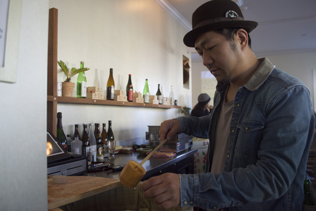 Stirling Sake owner Yuki Mori pours a cup of sake.