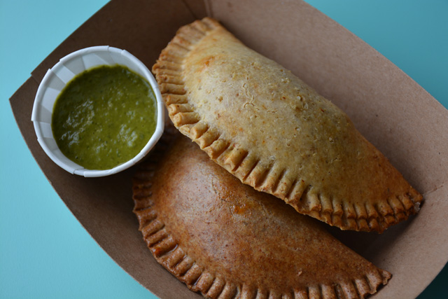 Two empanadas with salsa verde sauce (Credit: Monique Singh-Roy)