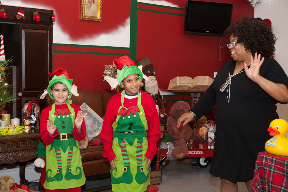 Dhonna Goodale with elves Valentino Abate, 8, of Mastic Beach and Jaysean Pittman, 8, of Flanders.