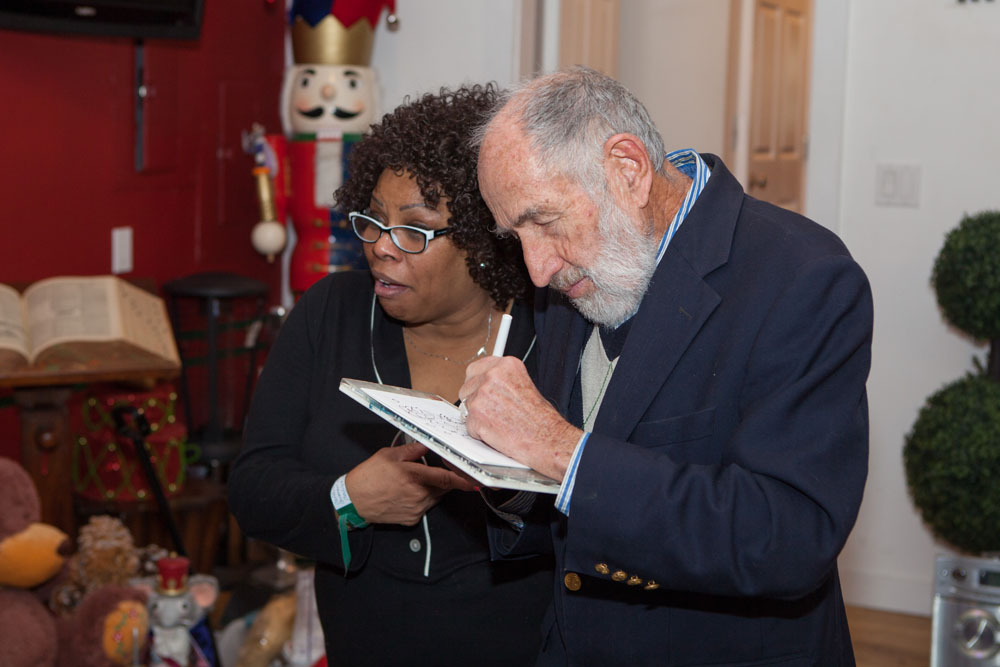 Animator Don Duga, creator of Frosty the Snowman, sketches as Dhonna Goodale looks on. 