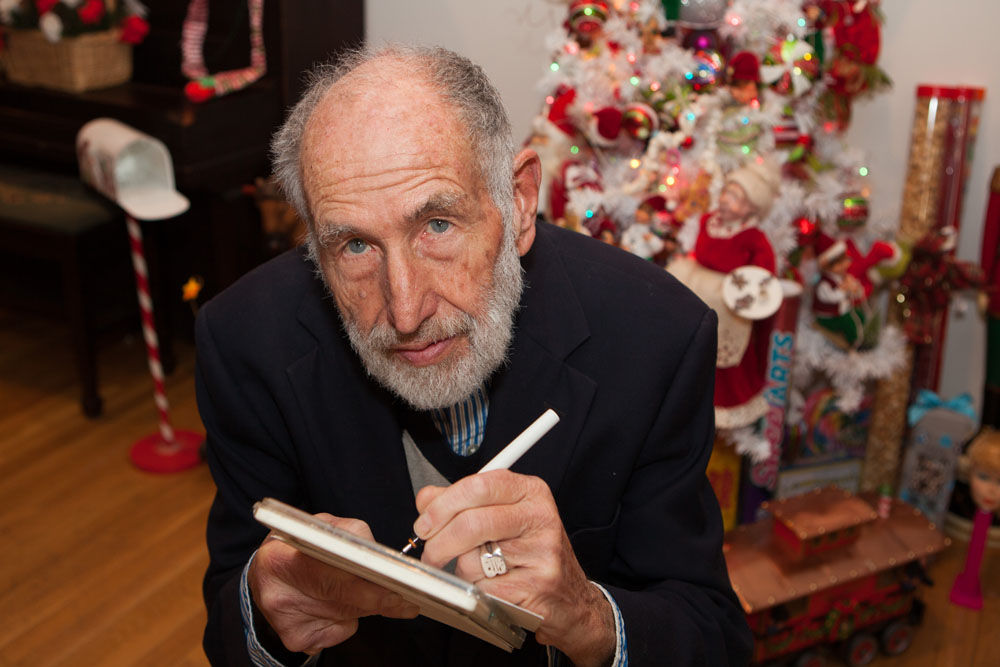 The artist sketches the photographer as she takes his picture.