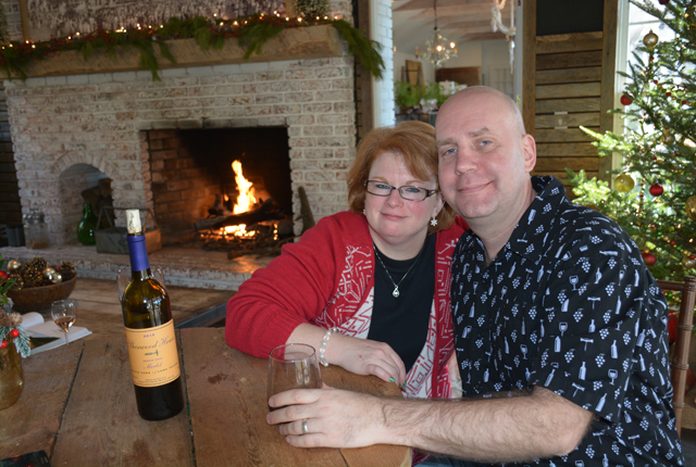 David and Tara Triebig of Mastic watch the ice carving from inside the warm tasting room.