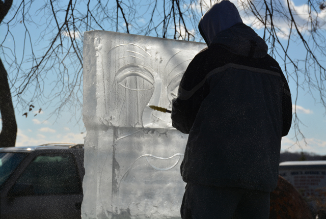 Using a small chainsaw, Daly carves out the features of Santa's Throne.