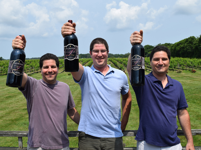 Kareem, Nabeel and Salim Massoud of Paumanok Vineyards hold three of the winery’s four 93-point wines, as awarded by The Wine Advocate. (Credit: Vera Chinese)