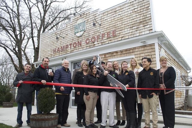 Hampton Coffee Co. owner Jason Belkin (center) surrounded by Riverhead Town officials cut the ribbon on the new Aquebogue coffee shop.