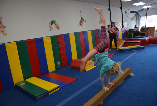 7-year old Clare McKenzie shows her prowess on the balance beam (Credit: Monique Singh-Roy)