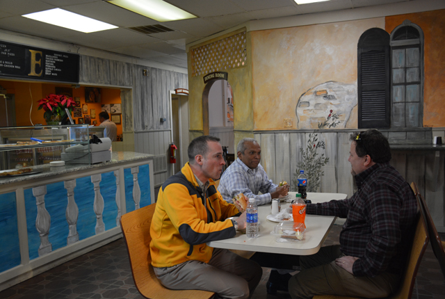 Diners at Emilio's sit surrounded by Oberlander's art on the walls and pizza counter (Credit: Monique Singh-Roy)