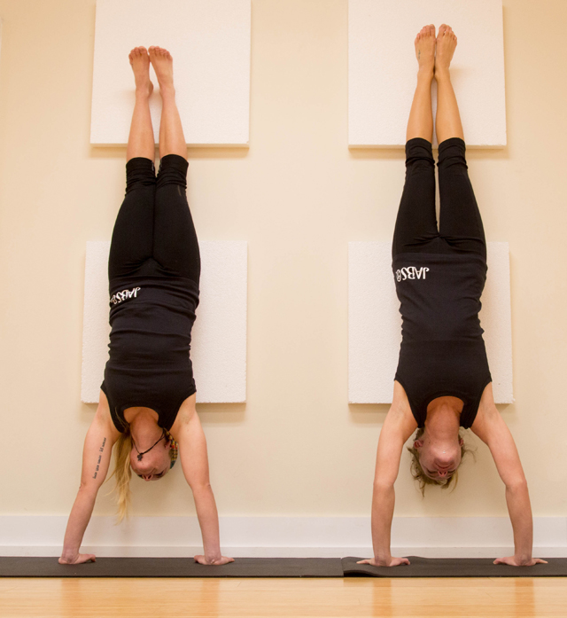 Katie Coe of Mattituck and Stephanie Mincieli of Laurel perform inversions at JABS in Cutchogue. (Credit: Madison Fender)