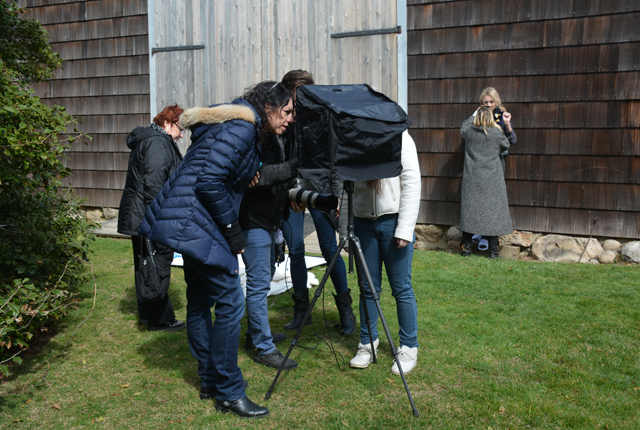 The fashion team examines a monitor to see how the pictures are turning out.