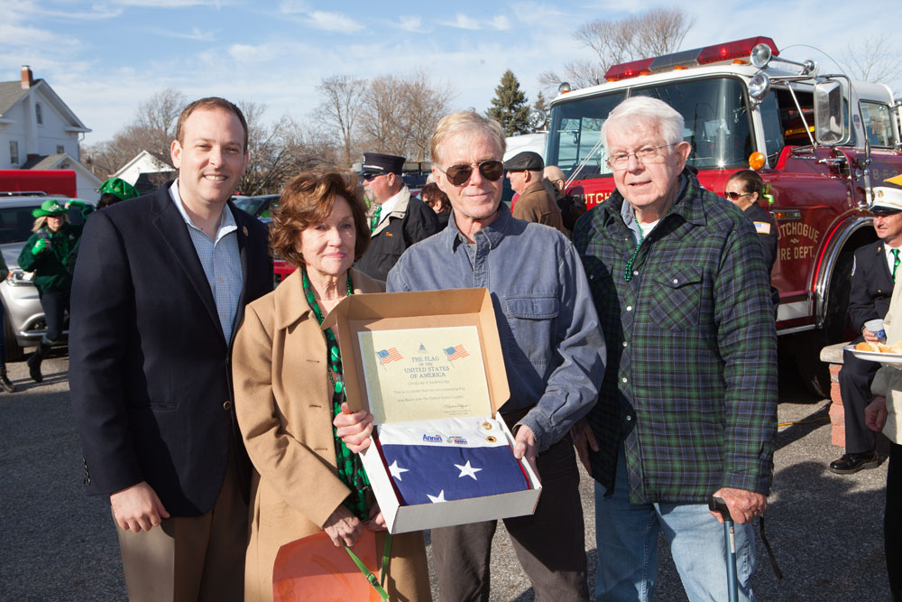 Congressman Lee Zeldin (left) presents members of the Cutchogue-New Suffolk Historical Council with a flag that was flown over the Capitol building. The flag will fly in the Cutchogue Village Green. From left in the photo: Congressman Zeldin, Rose Ann Burns, president of the historical council, Robert Snowden, and local historian Jim Grathwohl. 