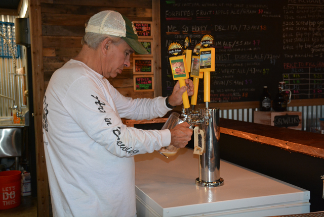 Jim Hull pouring up some of his Forbidden Fruit apple ale. (Credit: Monique Singh-Roy)
