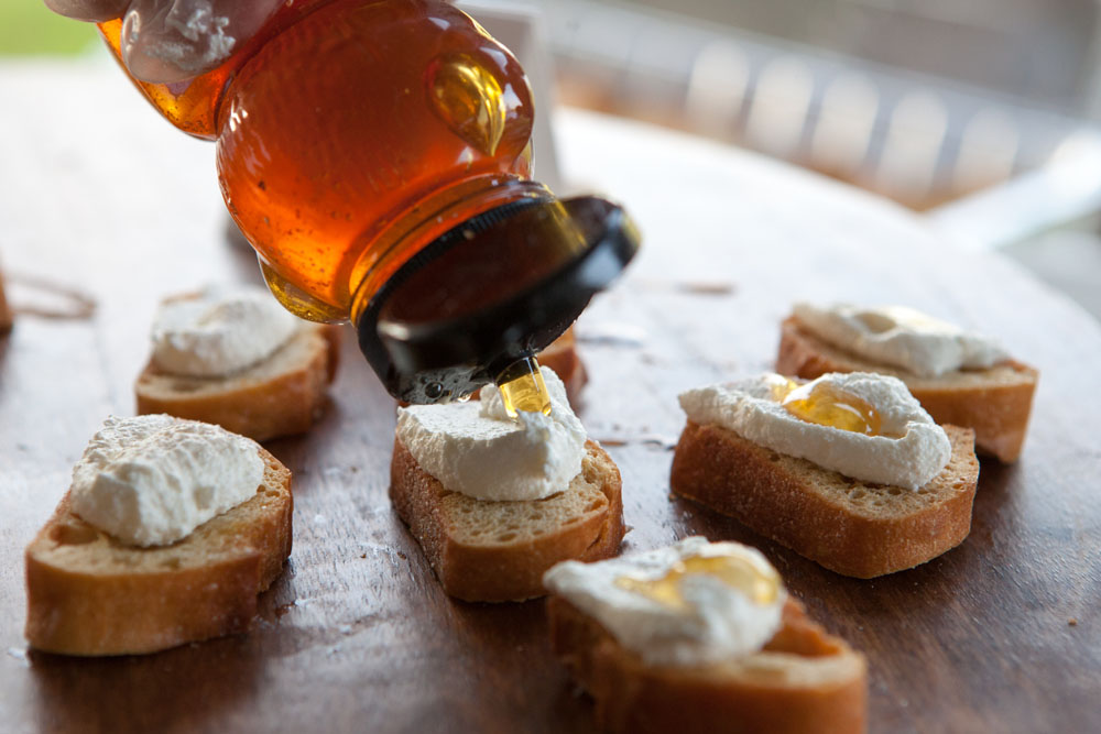 A touch of honey on a sample from Lombardi's in Mattituck. (Credit: Katharine Schroeder)