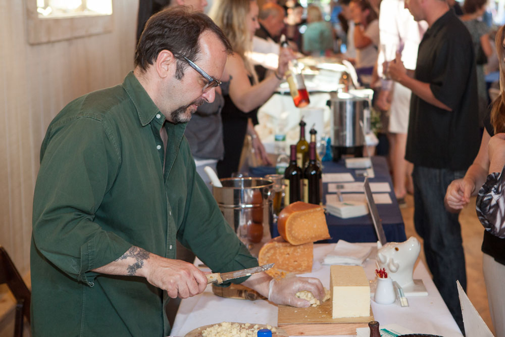 The Village Cheese Shop's owner Michael Affatato prepares samples. (Credit: Katharine Schroeder)