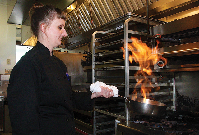 Chef Kasia making a bourbon maple glaze reduction for a grilled pork chops dish. (Credit: Barbaraellen Koch)