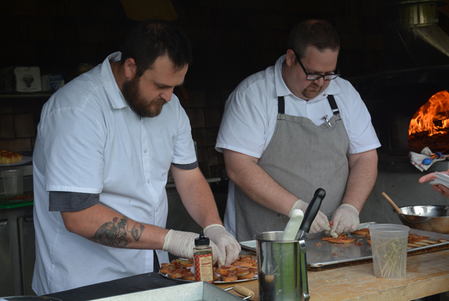 Chefs Jeffrey Cochrane and Dan Edgett making culinary magic in the outdoor kitchen.