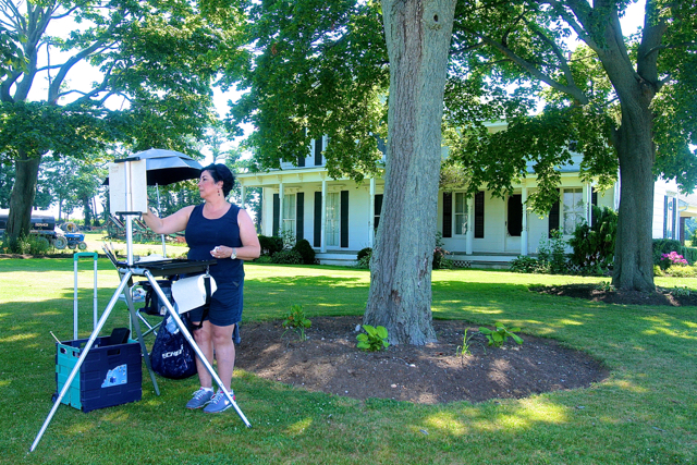 Christine Mistretta Dupuis of Riverhead set up her easel on the front lawn of the Sidor farmhouse on Oregon Road. (Credit: Barbaraellen Koch)