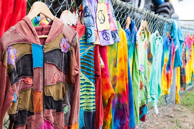 Colorful shirts hang on a fence, still a little damp from the downpour on the first day of the fair. 