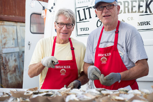 SPAT volunteers Jeff Chagnon and Steven Schnee shuck oysters at the Little Creek Oyster truck.