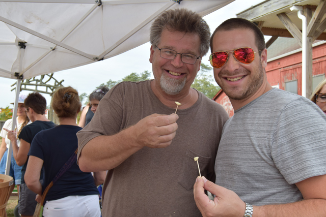 Wayne Carrier of Middle Village and his son Brandon of Massapequa enjoy a taste of garlic.