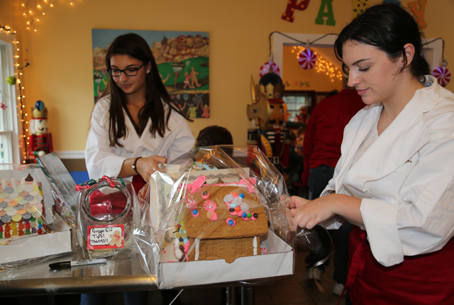 Santa's helpers and Gingerbread University employees Krista Farrell, of Riverhead, and Manager Christina Ragone, of Mattituck, wrapped up all the gingerbead houses when it was time to go home.