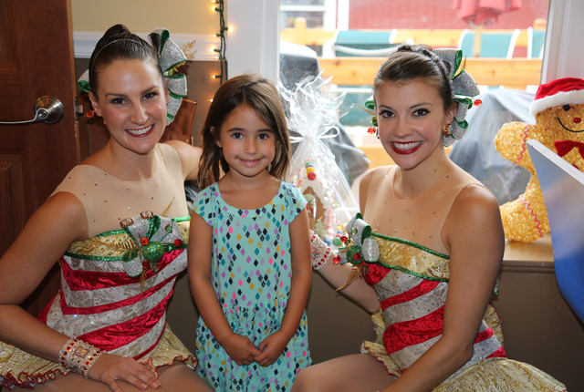 Rockettes Linda Farrell and Courtney Rottenberder pose with 5-year old Brielle Butofsky of East Moriches.