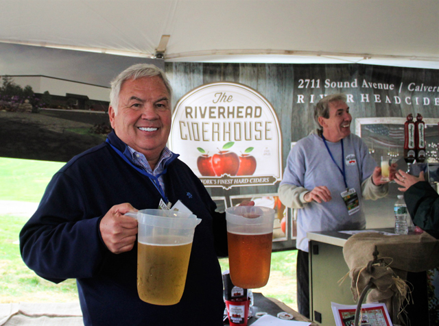 John King (owner of Riverhead Ciderhouse and J King’s Food Service) holding pitchers available for sampling.