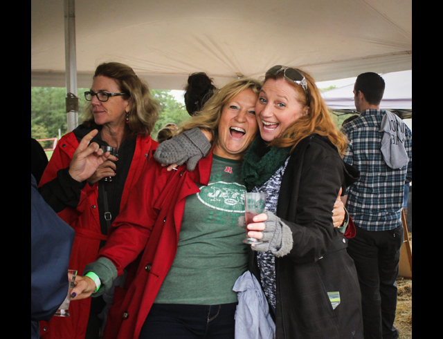 Kim Viola (left) and Maura Fallon (right) dance under the Strongbow Hard Cider tent. In the background is their friend Mary Lou Walsh. All three women from Riverhead 