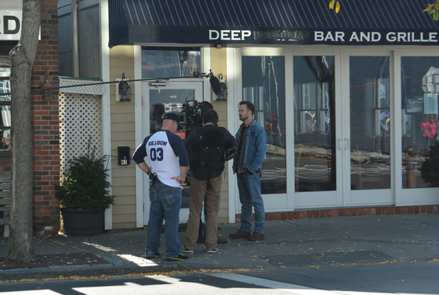 Rockmond Dunbar and Aaron Paul shoot a scene for "The Path" in front of Deep Water Bar & Grill in Greenport.