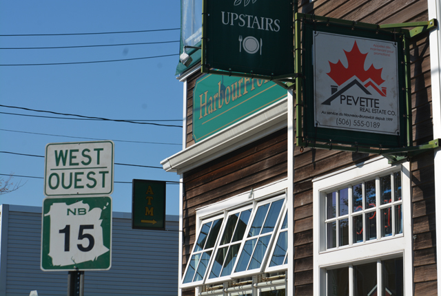 Harbourfront Deli made up to look like a Canadien real estate office. Notice the Pevette sign with the Maple leaf and then there's the temporary green and white traffic sign that reads west in English and French with a map of New Brunswick.
