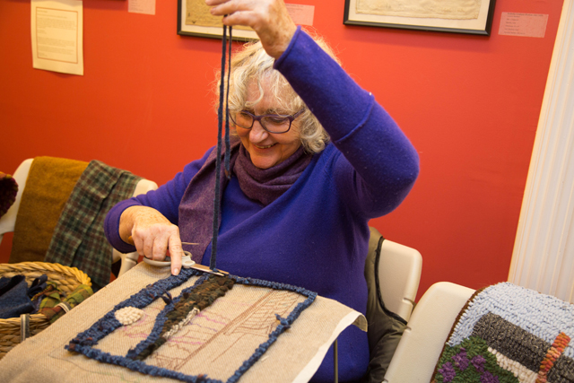 Gail Horton of Greenport demonstrates her needle work during one of the tours.