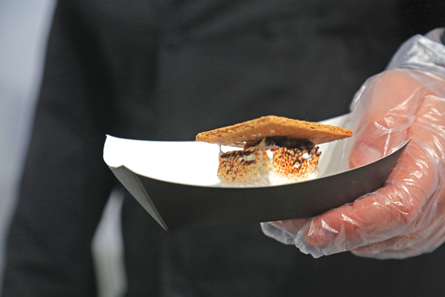 Evan Gappelberg holds up a freshly made s'more. (Credit: Vera Chinese)
